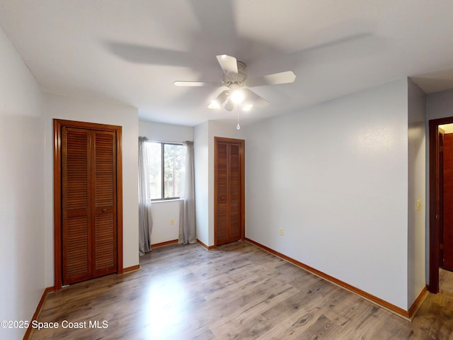 unfurnished bedroom with ceiling fan and light hardwood / wood-style floors