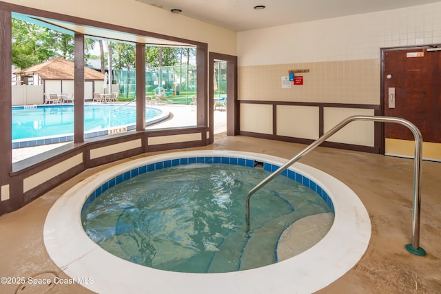 view of swimming pool featuring an indoor in ground hot tub