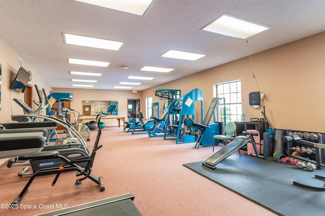 exercise room featuring a textured ceiling