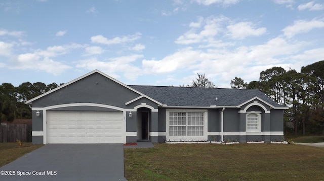 ranch-style home with a front lawn and a garage