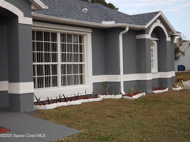 view of side of home featuring a lawn