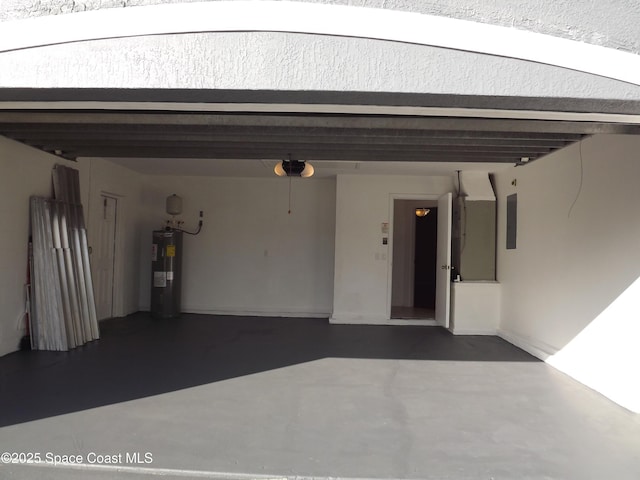 garage featuring electric panel, electric water heater, and a garage door opener