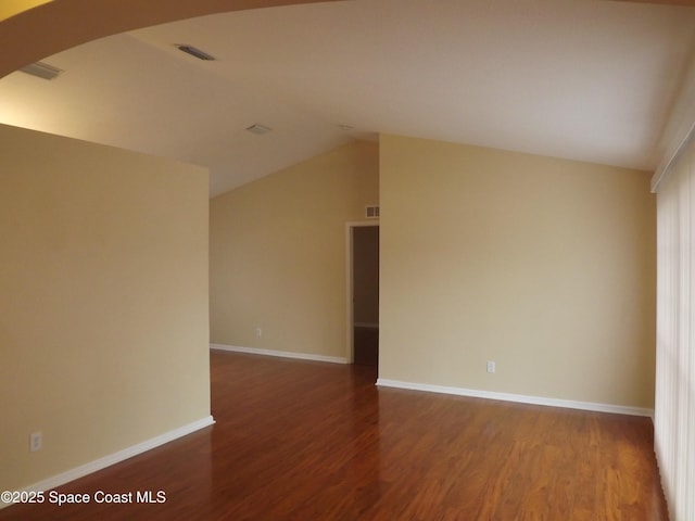 unfurnished room with lofted ceiling and hardwood / wood-style floors