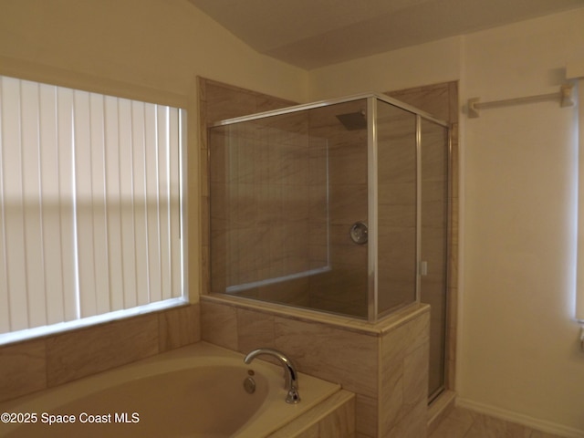 bathroom featuring independent shower and bath