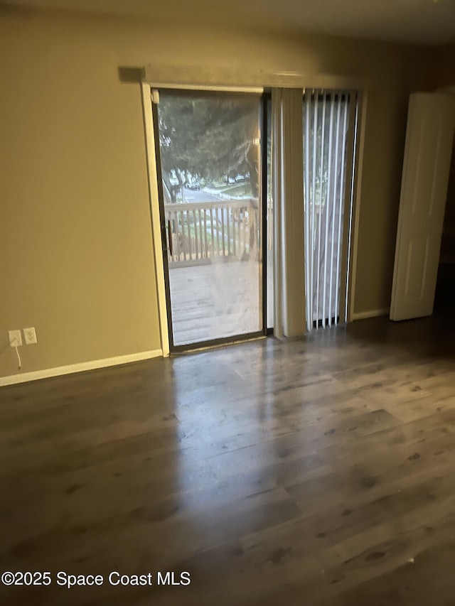 spare room with dark wood-type flooring