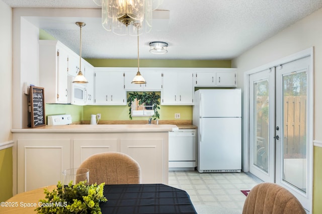 kitchen with french doors, a textured ceiling, hanging light fixtures, white appliances, and white cabinets