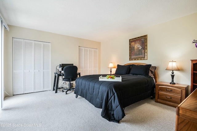 bedroom with carpet and two closets