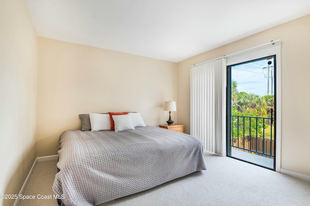 bedroom with access to exterior and carpet flooring