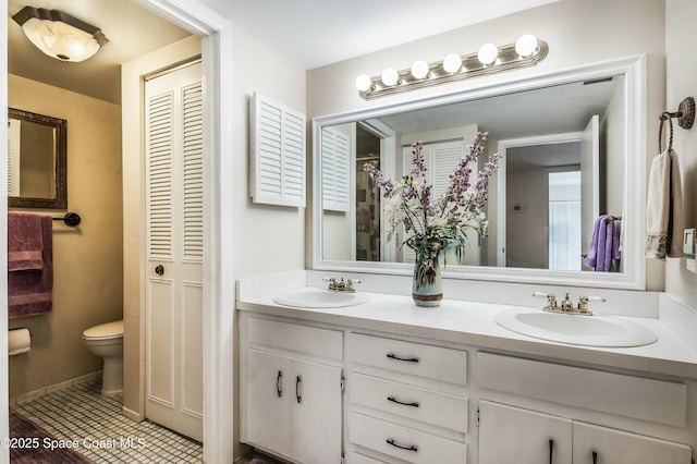 bathroom with a shower with curtain, vanity, tile patterned floors, and toilet