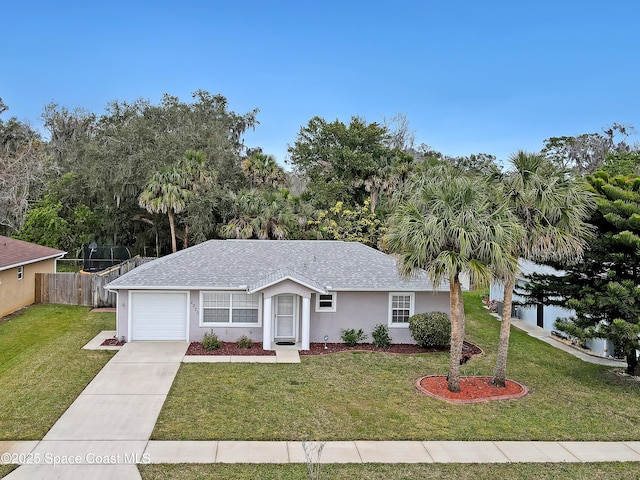 ranch-style home with a garage and a front lawn