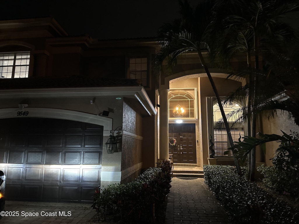 view of exterior entry at night