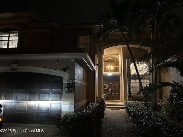 view of exterior entry at night