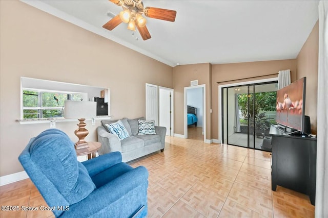 living room featuring ceiling fan, vaulted ceiling, a wealth of natural light, and light parquet floors