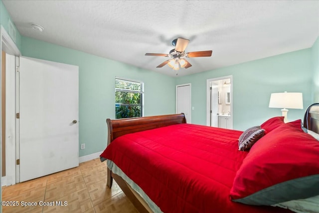 bedroom featuring ensuite bathroom, ceiling fan, light parquet floors, and a textured ceiling