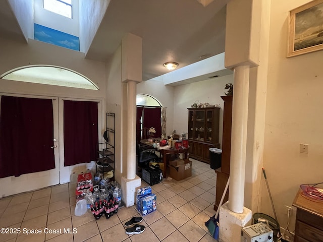 tiled foyer featuring decorative columns