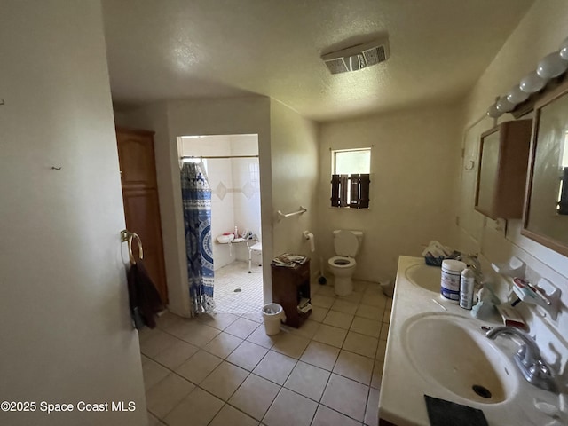 bathroom featuring walk in shower, tile patterned floors, toilet, a textured ceiling, and vanity