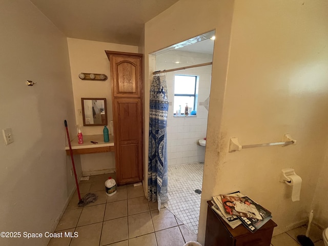 bathroom with tile patterned floors and a shower with shower curtain