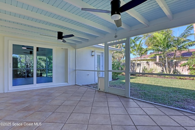 unfurnished sunroom featuring beamed ceiling