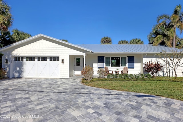 single story home featuring a front lawn and a garage