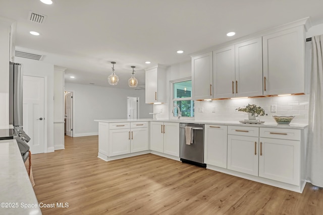 kitchen with dishwasher, pendant lighting, and white cabinetry