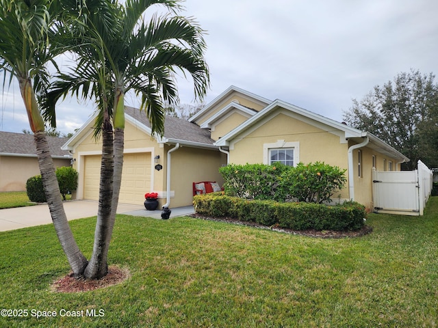 view of front of home featuring a garage and a front lawn