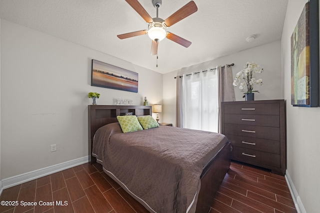 bedroom with a textured ceiling and ceiling fan