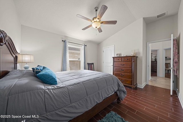 bedroom featuring vaulted ceiling, ceiling fan, and a textured ceiling