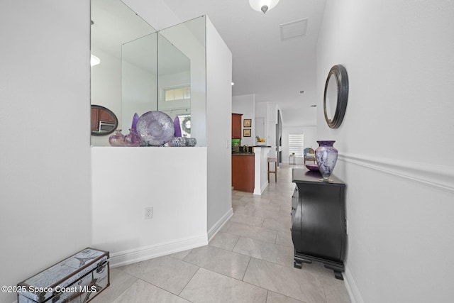 corridor featuring light tile patterned floors