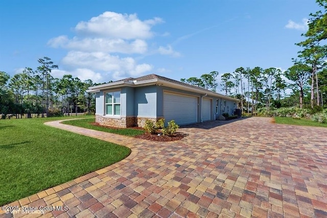 view of side of home featuring a garage and a yard