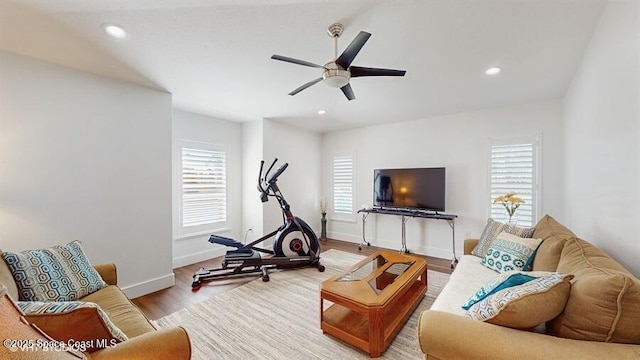 living room with hardwood / wood-style floors and ceiling fan