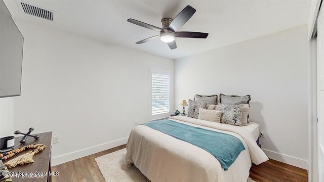 bedroom featuring wood-type flooring and ceiling fan