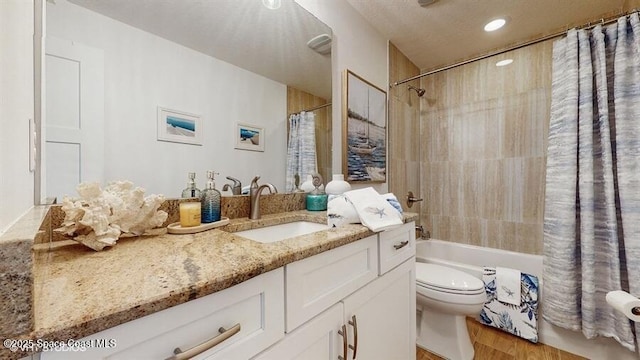 full bathroom with hardwood / wood-style flooring, vanity, toilet, and shower / bath combo with shower curtain