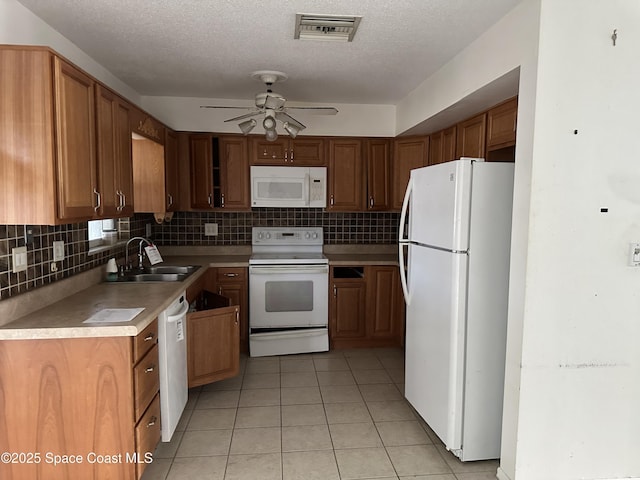 kitchen featuring white appliances, a textured ceiling, ceiling fan, light tile patterned flooring, and sink