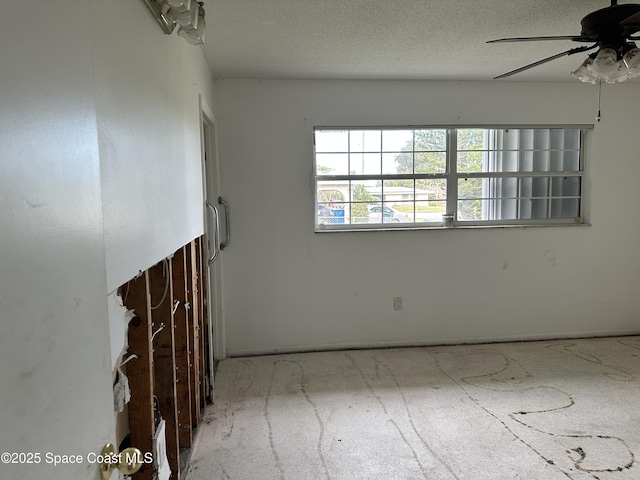 spare room featuring a textured ceiling and ceiling fan