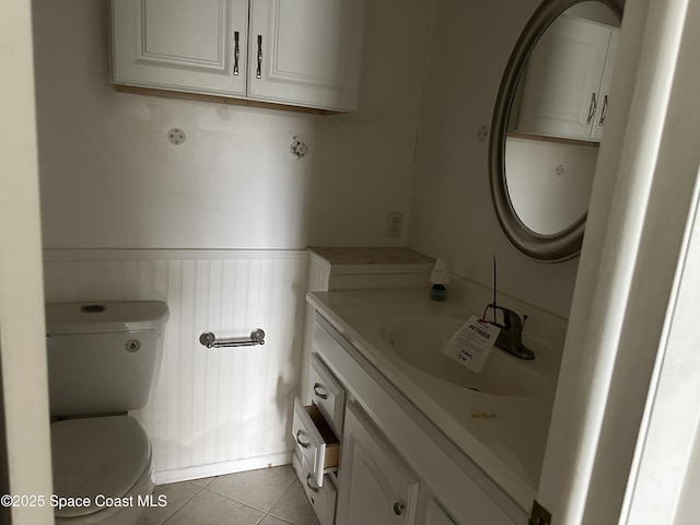 bathroom featuring toilet, vanity, and tile patterned floors