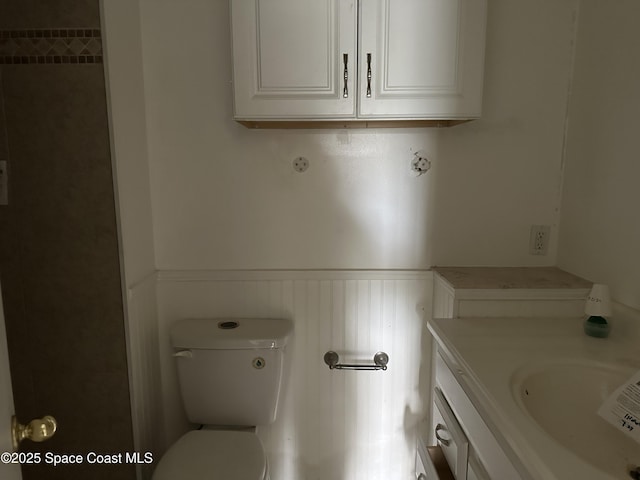 bathroom featuring vanity and toilet