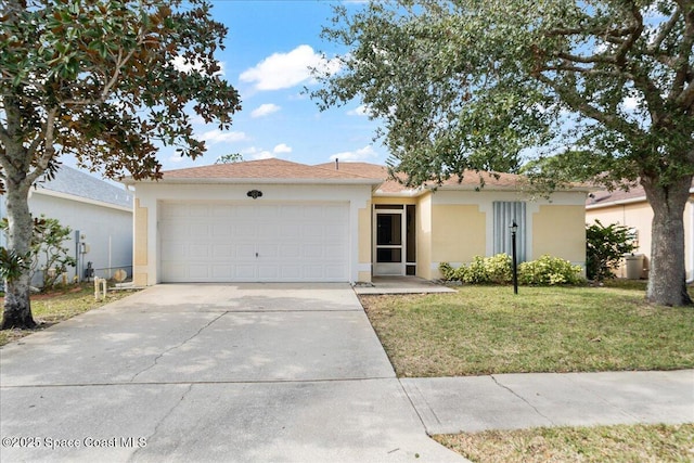 view of front facade with a front yard and a garage