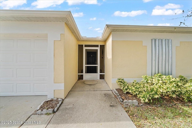 doorway to property with a garage