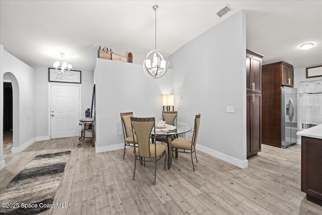 dining space featuring a chandelier and light hardwood / wood-style flooring