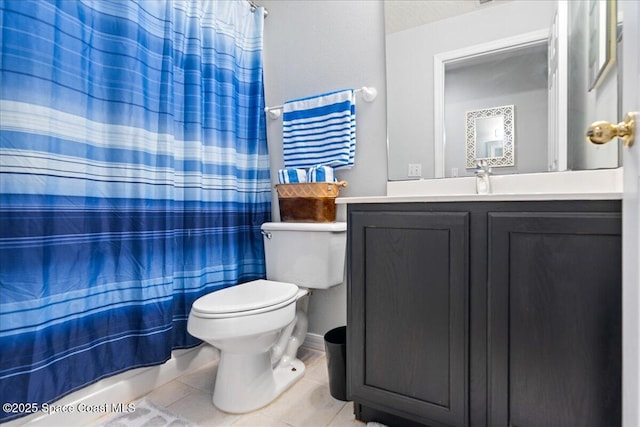 bathroom featuring toilet, vanity, tile patterned floors, and walk in shower