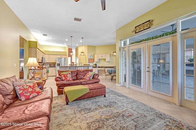 tiled living room featuring ceiling fan