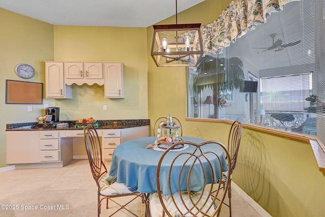 kitchen featuring white cabinetry, hanging light fixtures, light tile patterned floors, and a notable chandelier