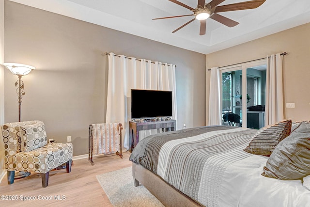 bedroom featuring ceiling fan, access to exterior, and light hardwood / wood-style floors