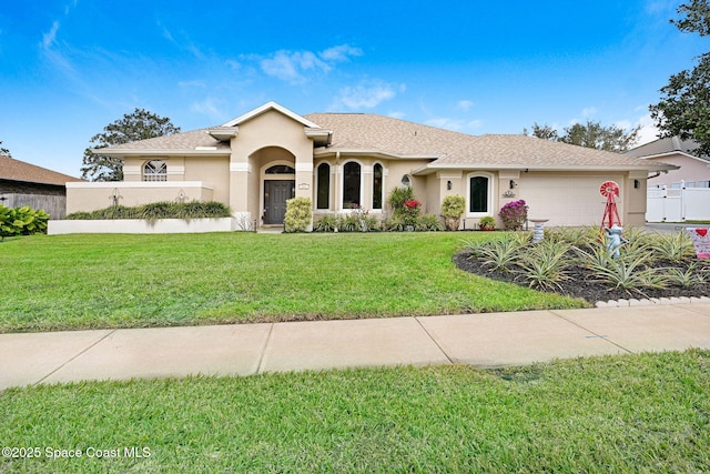 view of front of home featuring a front yard and a garage