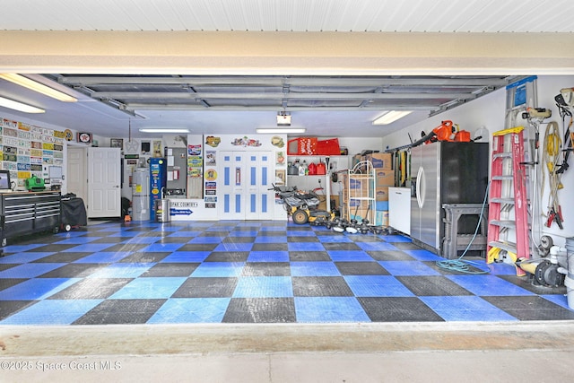 garage with stainless steel refrigerator with ice dispenser