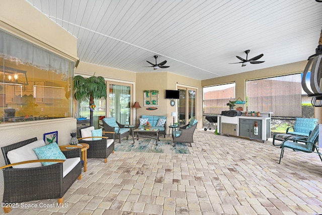 view of patio / terrace featuring ceiling fan and an outdoor living space