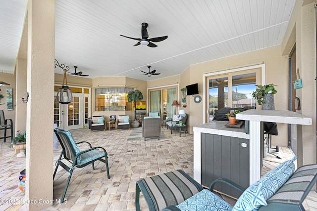 view of patio with an outdoor living space and ceiling fan