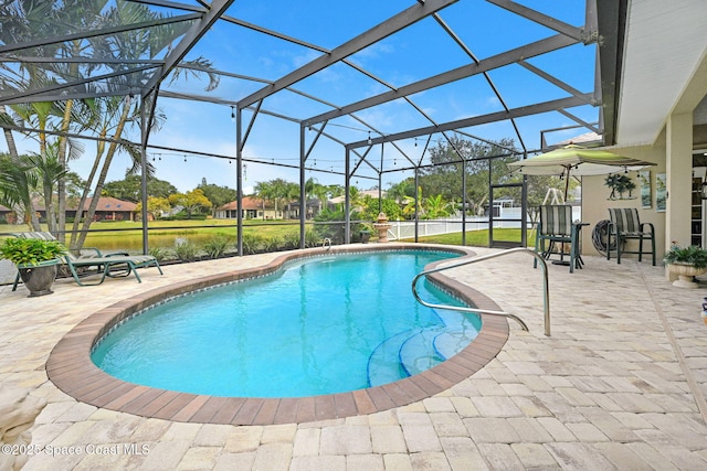 view of swimming pool featuring glass enclosure, a water view, and a patio