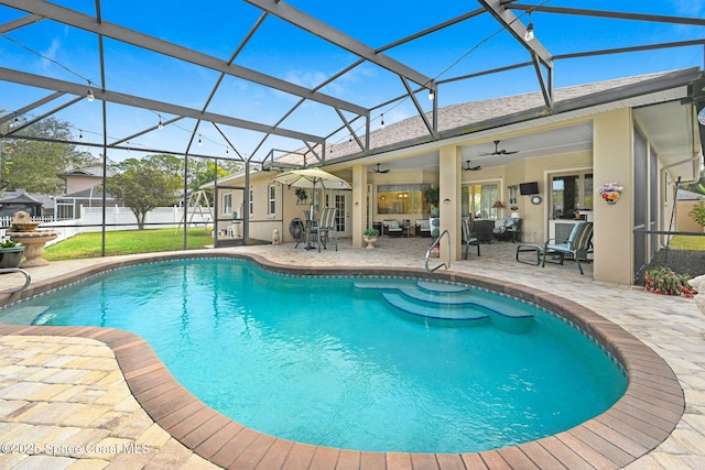 view of swimming pool featuring a lanai, ceiling fan, and a patio area