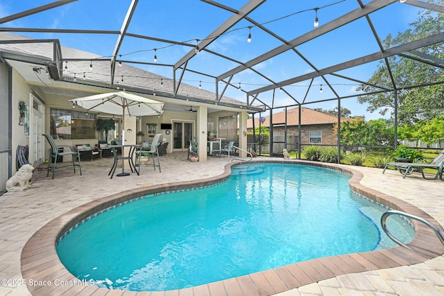 view of swimming pool featuring a lanai and a patio